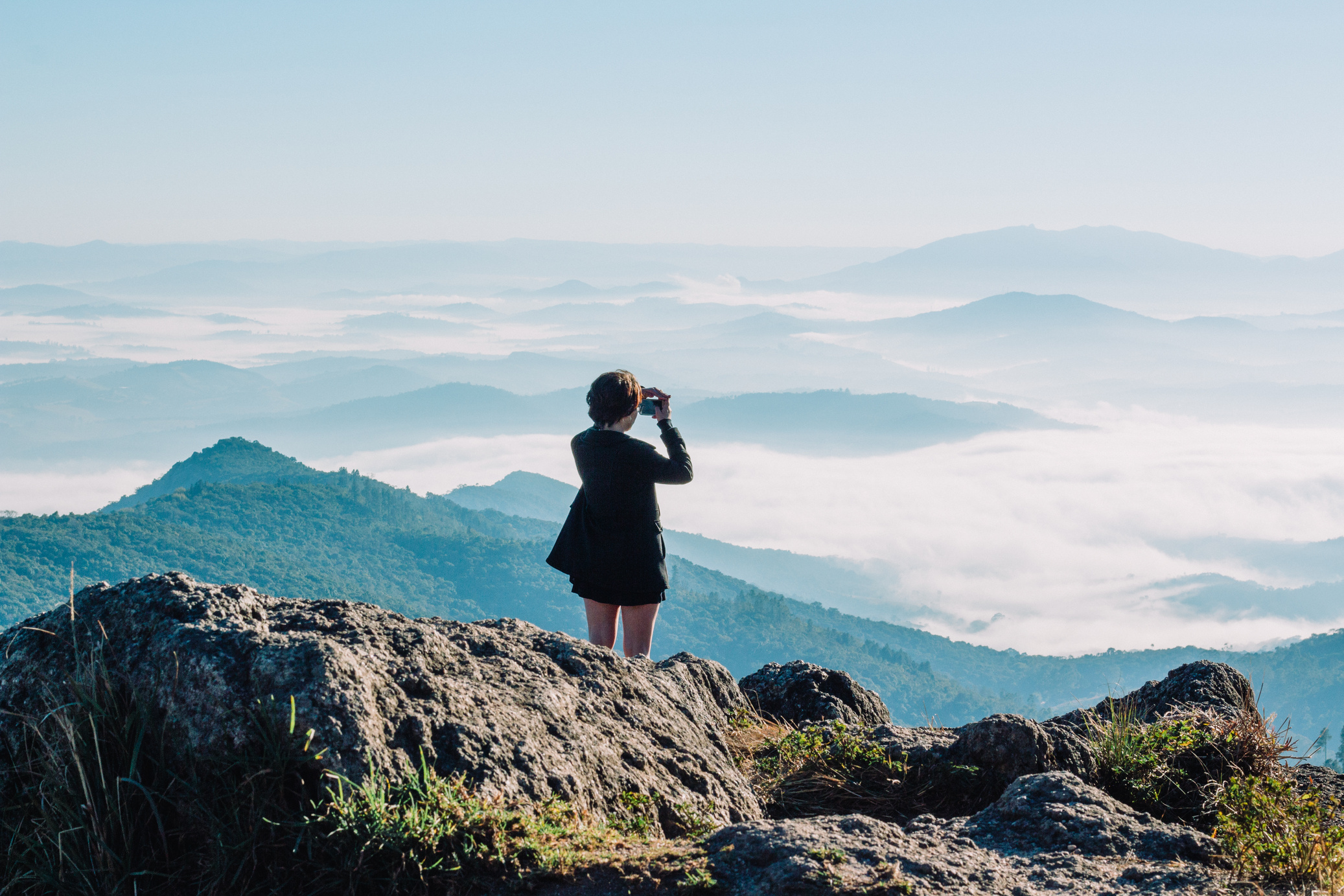 Woman Taking A Picture Of Mountains
